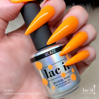 en Vogue Lac It! Blaze bright, bold tiger orange crème UV/LED gel nail polish for professional nails and extensions on long point manicure holding bottle