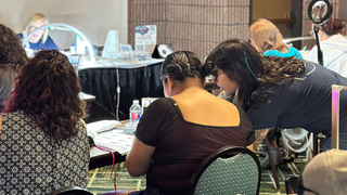 students in a tradeshow classroom learning nail art and gel nail techniques
